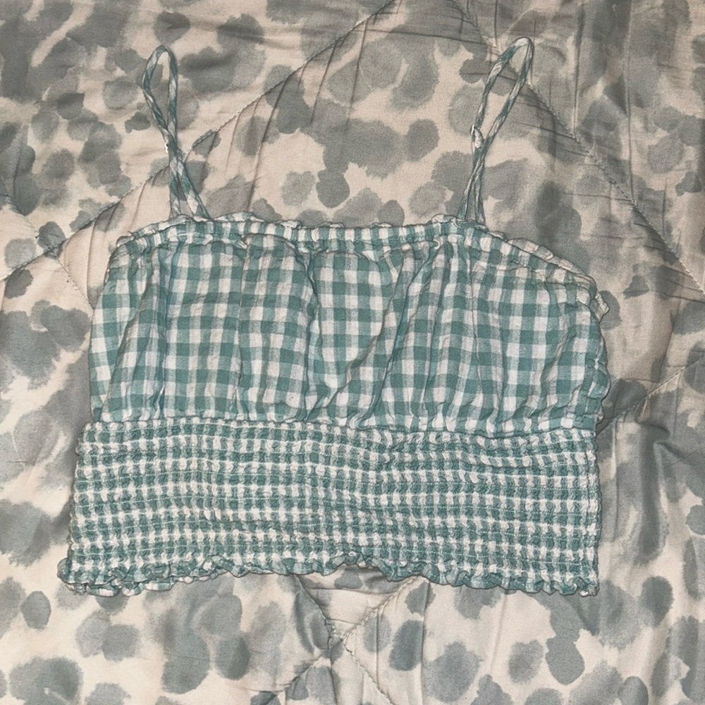 teal and white plaid tank top with tighter fit on the bottom and singe stomach
